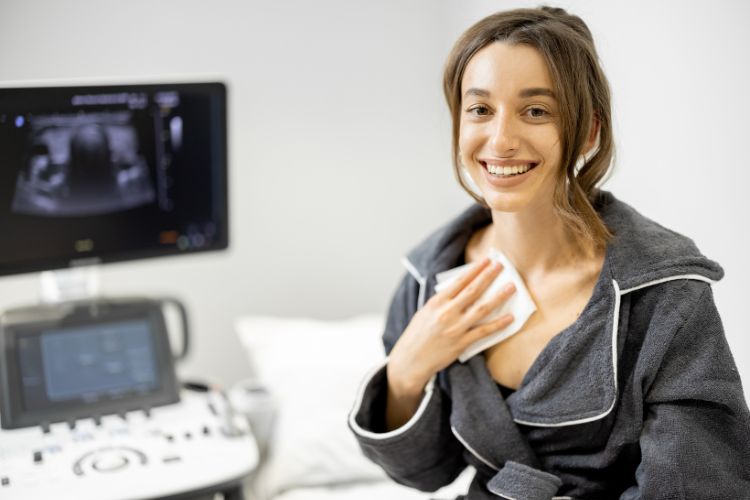 Smiling patient holding paper towel on her chest 