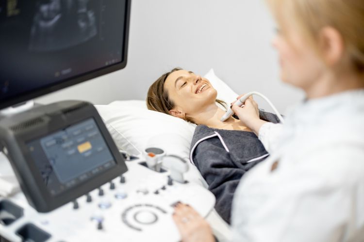 Happy patient undergoing thyroid scan