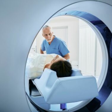 doctor looking into ct scanner