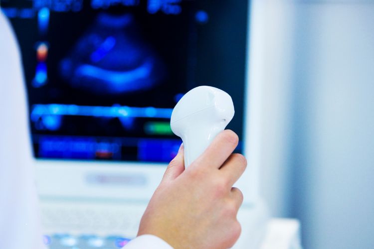 a doctor holding ultrasound device